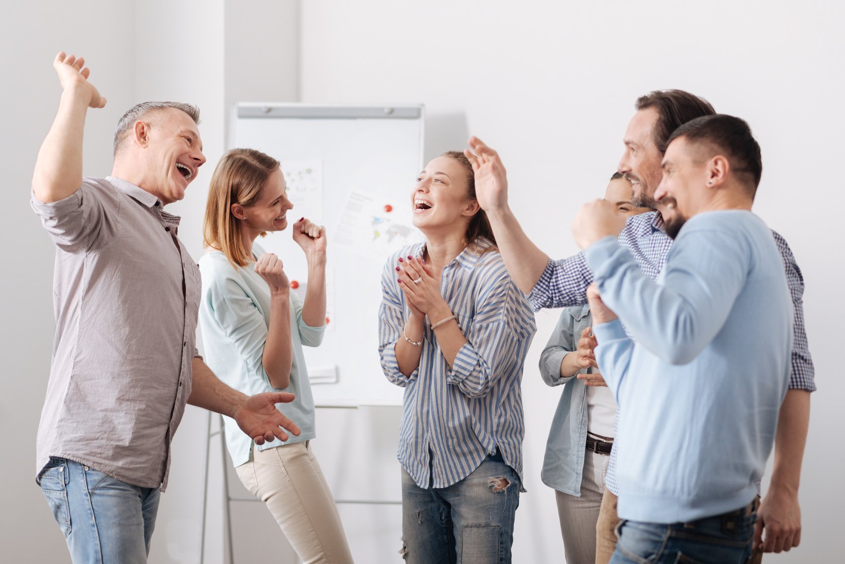 Group of office workers expressing positivity after teambuilding